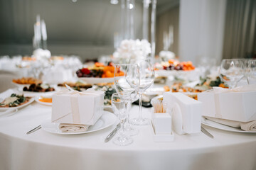 Fototapeta premium Elegant white table setting prepared for a grand wedding reception event