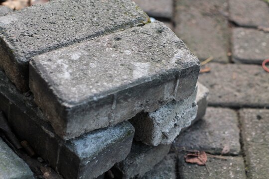 Stacked Concrete Pavers And Weathered Brick Blocks With Moss And Fallen Leaves Outdoors