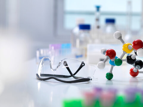 Close-up of molecular structure with protective eyewear on table in laboratory