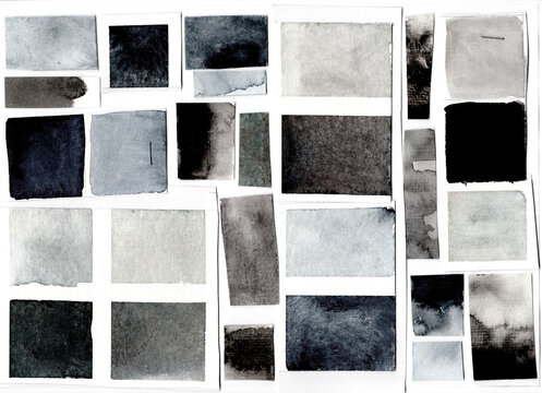 Different shades of grey watercolor swatches on white paper