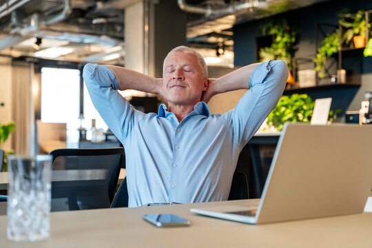 Business executive relaxing at the office desk during a break
