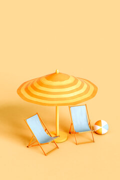 Studio shot of beach umbrella, two empty deck chairs and beach ball