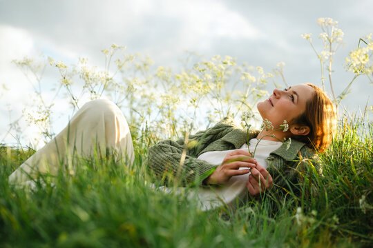 Relaxing and practicing mindfulness in a grassy summer meadow