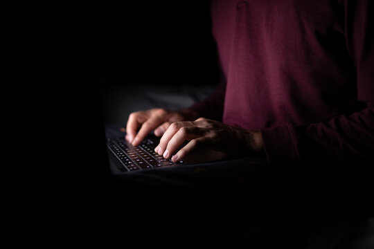 Businessman working late on laptop at home office