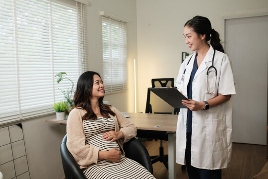 Pregnant woman consulting doctor during prenatal checkup