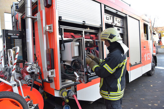 Firefighter standing at fire engine