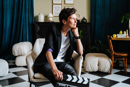Thoughtful director sitting on chair at film set