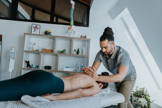 Female patient receiving spine massage in medical practice