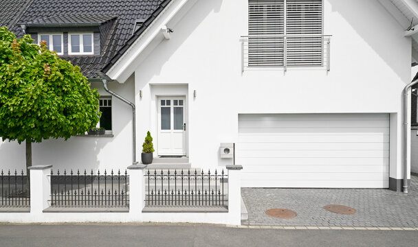 Germany, Cologne, white new built one-family house with garage