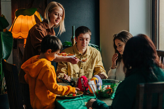 Happy family having Easter dinner at table in home