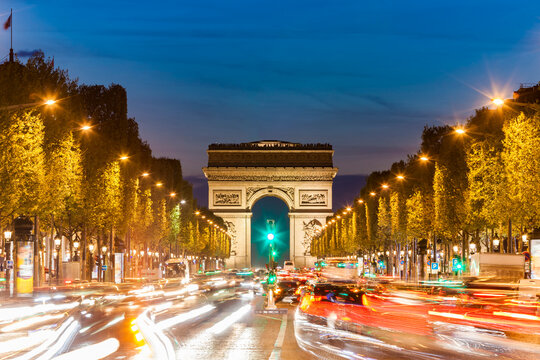 France, Paris, Champs-Elysees, Arc de Triomphe and cars at night with light trails
