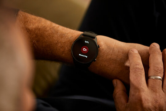 Man measuring body functions on smart watch at home