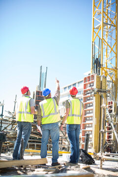 Three construction workers in construction site