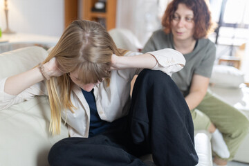 Obraz premium Teenager covering ears experiencing family communication conflict