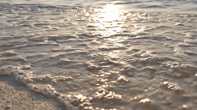 Ocean water washing over white sand. Sea waves moving. Tide flowing sand foam shore surf grain.