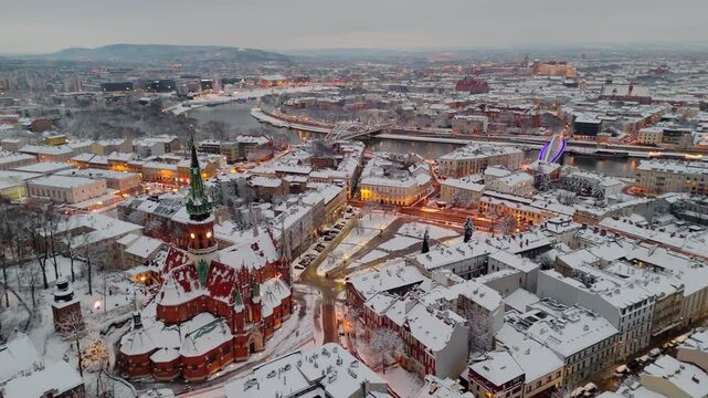 An aerial flyover of St. Joseph's Cathedral in Krakow at sunset in winter in Poland.