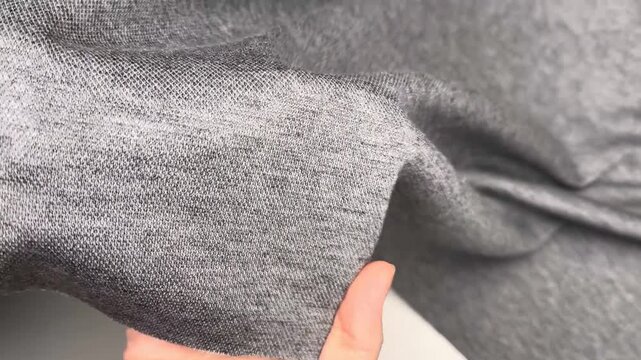 Angora mustang is a mid weight grey knitted fabric ideal for sewing warm dresses and suits as it features an elastic texture that drapes well and maintains a soft feel for many clothing applications