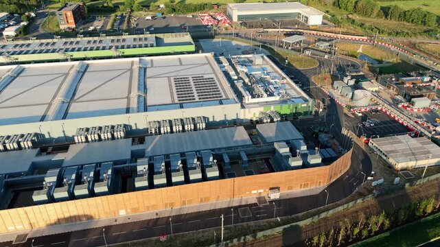 High-angle drone perspective looking down at the massive external cooling infrastructure of a modern technology data centre near London