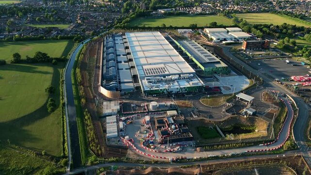 High-angle drone perspective looking down at the massive external cooling infrastructure of a modern technology data centre near London