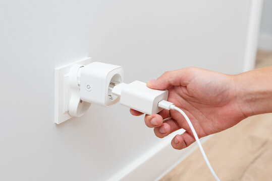 Man plug charger into smart socket