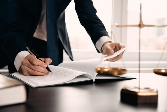 Wooden gavel on table. Attorney working in office