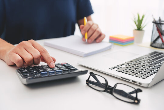 Man planning home budget and using calculator