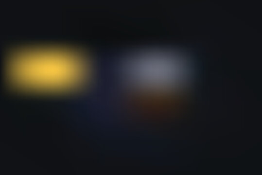 Blurry scene with yellow object and white shape on dark transparent background