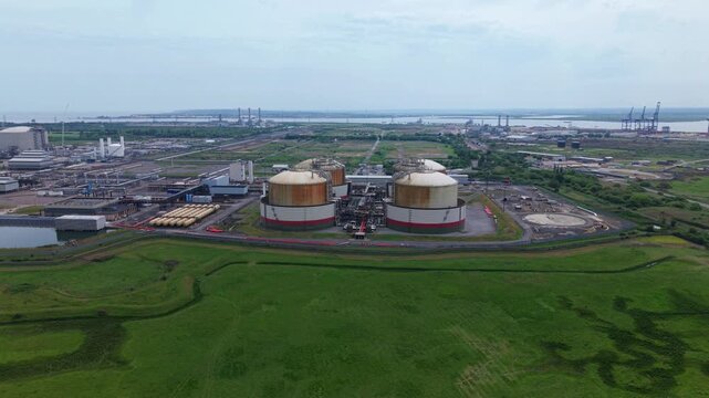 High aerial view of Isle of Grain LNG and LPG storage terminals with cryogenic silos and pipework manifolds, UK