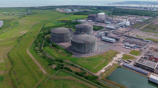 Close up aerial view of giant liquefied natural gas LNG storage tanks at the Grain LNG import terminal on the Isle of Grain, Kent, UK.