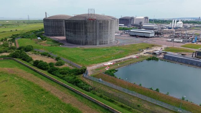 Close up aerial view of giant liquefied natural gas LNG storage tanks at the Grain LNG import terminal on the Isle of Grain, Kent, UK.