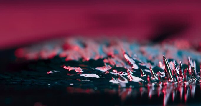 Explore captivating abstract visuals of metal particles dynamically reacting to magnetic forces on a dark backdrop, ideal for enhancing motion graphics and other creative projects