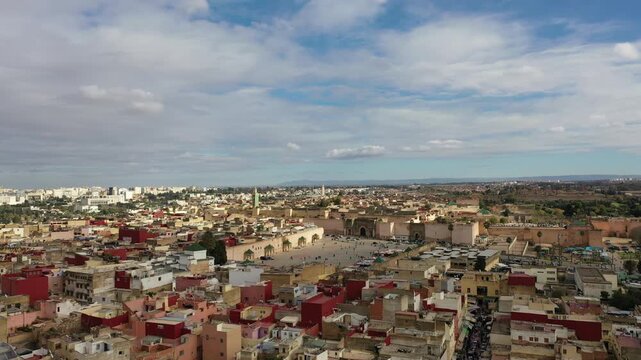 Drone aerial view of Meknes, one of Morocco&rsquo;s four imperial cities and a UNESCO World Heritage destination. The scene features El Hedim Square, Bab Mansour, historic fortifications, and the living her