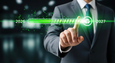 Obraz premium Businessman in suit interacts with digital progress bar displaying years 2026 and 2027, futuristic interface with green accents and blurred background