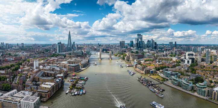 Panoramic view of the cityscape of London, England, during a sunny summer day with City and Tower Bridge