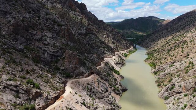 Aerial of Karasu River with the legendary hand-carved Stone Road visible on the cliff with rock carved tunnel in Canyon in Kemaliye, Turkey.