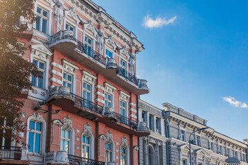 Obraz premium Classic ornate building facade in Odesa city streets with blue sky. Architectural details and urban charm