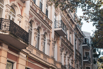 Fototapeta premium Historic buildings with detailed balconies and classic architecture in urban setting