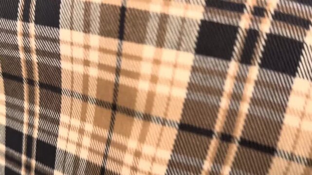This versatile medium-weight suit fabric features a classic beige and black plaid pattern with a smooth matte finish suitable for tailoring professional blazers and office clothing