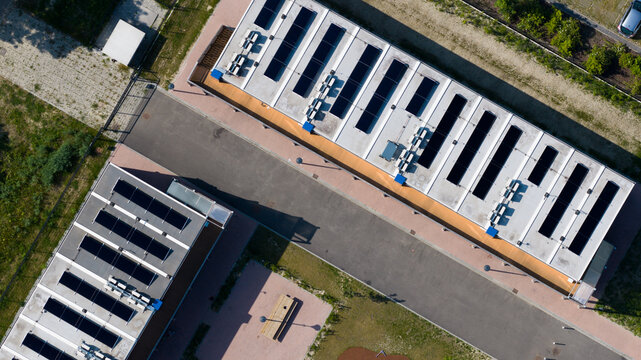 Aerial view of the KaFra Zevenbergen modular housing complex featuring solar panels on rooftops and paved walkways in Zevenbergen, Noord-Brabant, Netherlands.