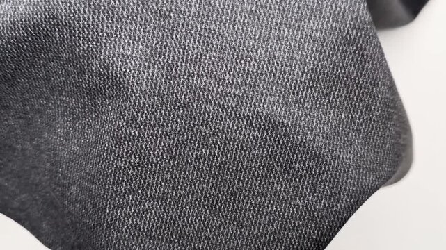Dark grey melange knit textile featuring a soft stretchy texture and rhombus pattern ideal for sewing comfortable cardigans trousers and stylish apparel dresses.
