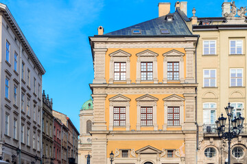 Obraz premium Charming European old town street with historic buildings and blue sky
