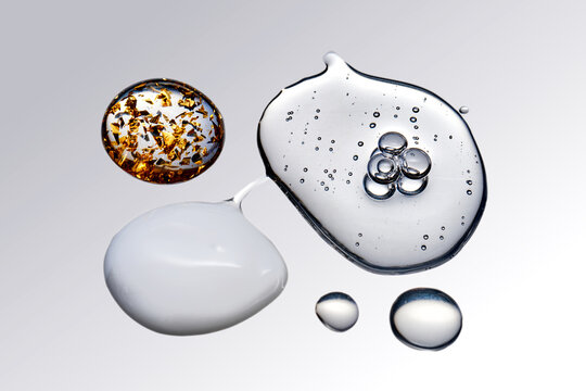 Skincare product drops with serum texture and gold flakes