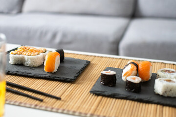 Assorted Sushi Selection Served on Slate Plates at Home © chandlervid85
