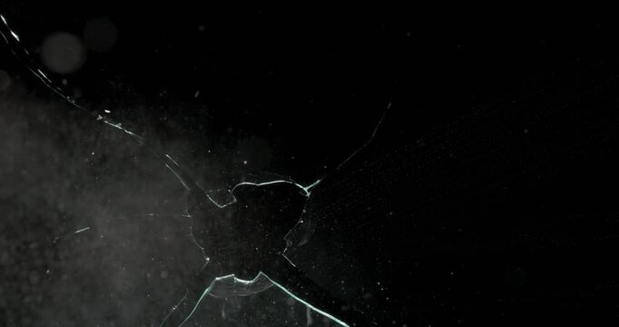This dynamic and visually stunning abstract footage showcases the spontaneous breakage of glass against a dark backdrop. It is ideal for use in motion graphics and various visual effects projects