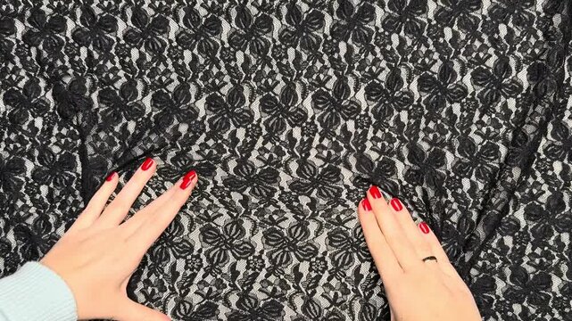 Black floral guipure fabric with intricate lace details presenting elastic properties and density suitable for elegant apparel manufacturing and textile industry applications