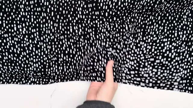 Black rayon staple textile displaying a white dash pattern suitable for creating lightweight summer dresses and breathable blouses featuring an airy drape