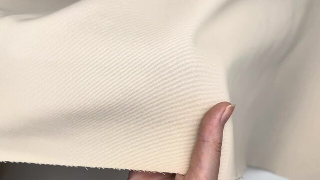 Thick pale beige cotton twill textile with visible diagonal weave suitable for creating durable garments and structured sewing applications requiring sturdy fabric.