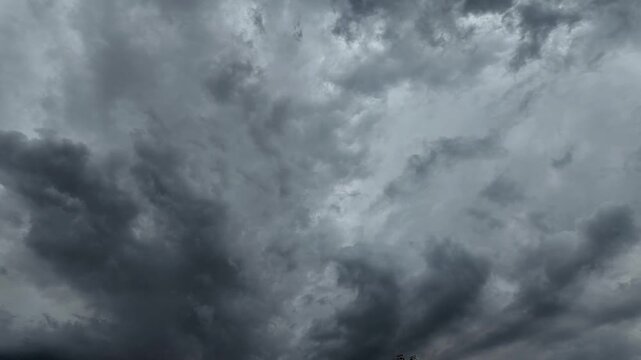 Black and gray clouds cover the sky. Clouds are approaching before a storm and rain with a thunderstorm