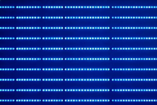 A structured array of dense blue circular LED light emitters arranged in parallel horizontal rows on a dark blue background.