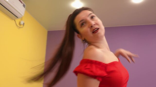 Passionate Caucasian female performs bachata steps with joy in a rehearsal studio. Concept of dance learning, well-being, and artistic fitness Close up of legs